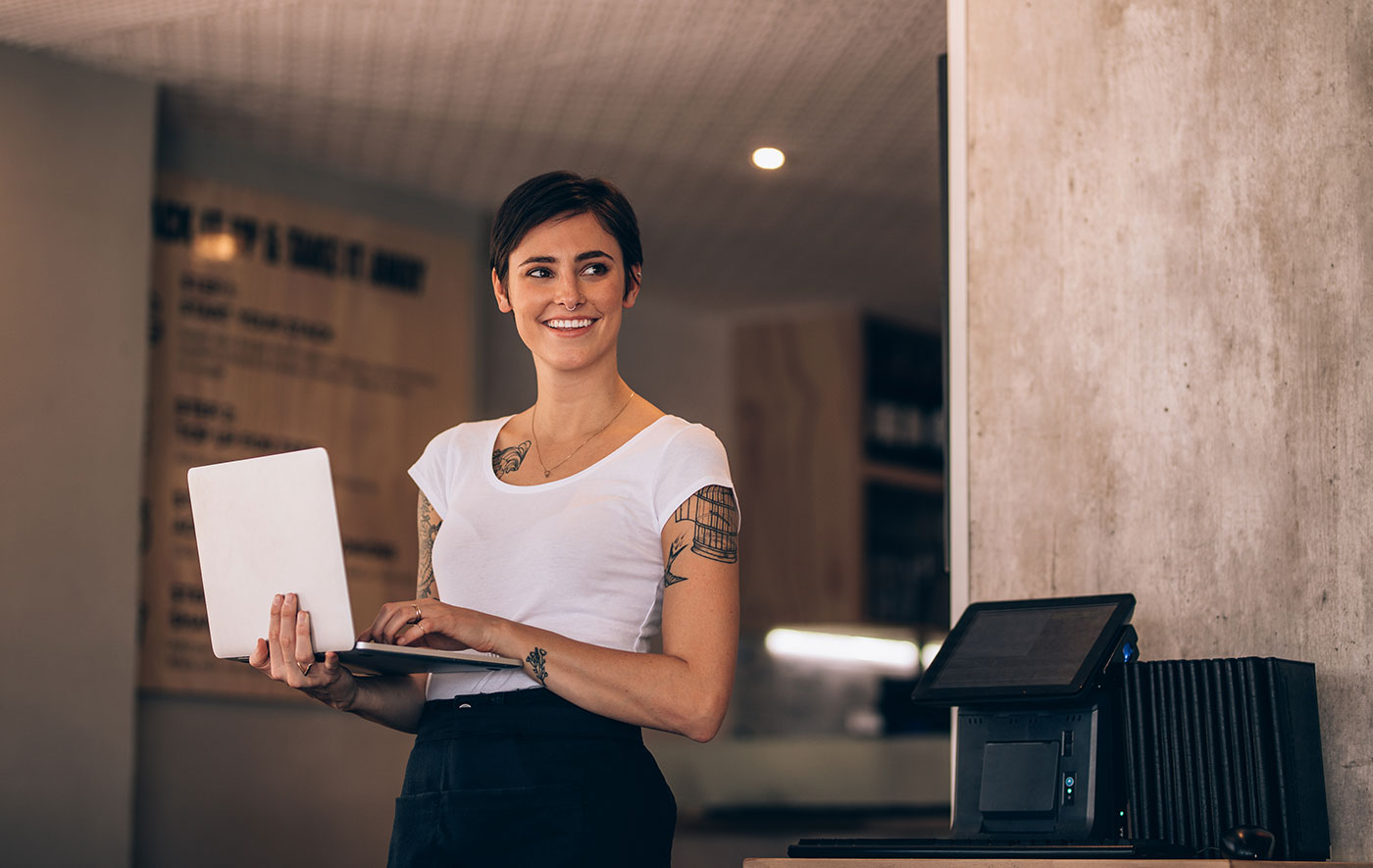 lady with tattoos on laptop