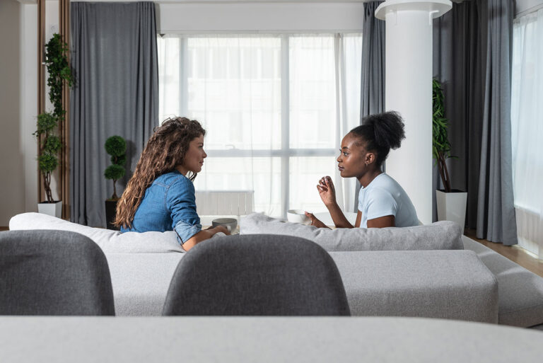 women talking on couch